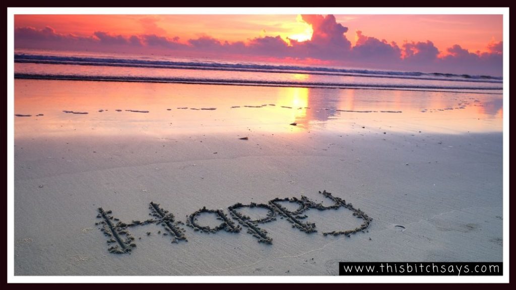 Happy carved into sand